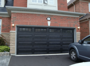 Black Garage Doors on Red Brick House