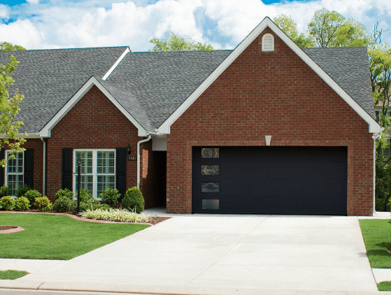 Black Garage Doors on Red Brick House Transformation