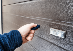 person using remote on garage door